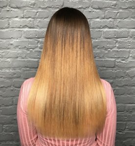 Woman with long brassy, orange hair after bleaching